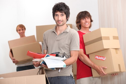 Careful packing of fragile household items with boxes in Stpauls
